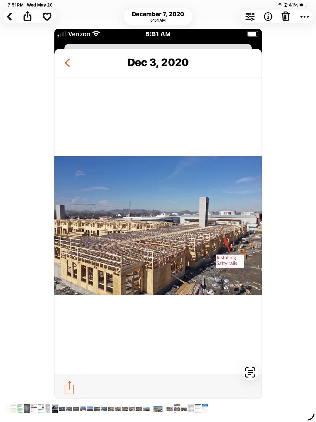 Wide aerial view of large multi-building residential framing project with safety rails installed