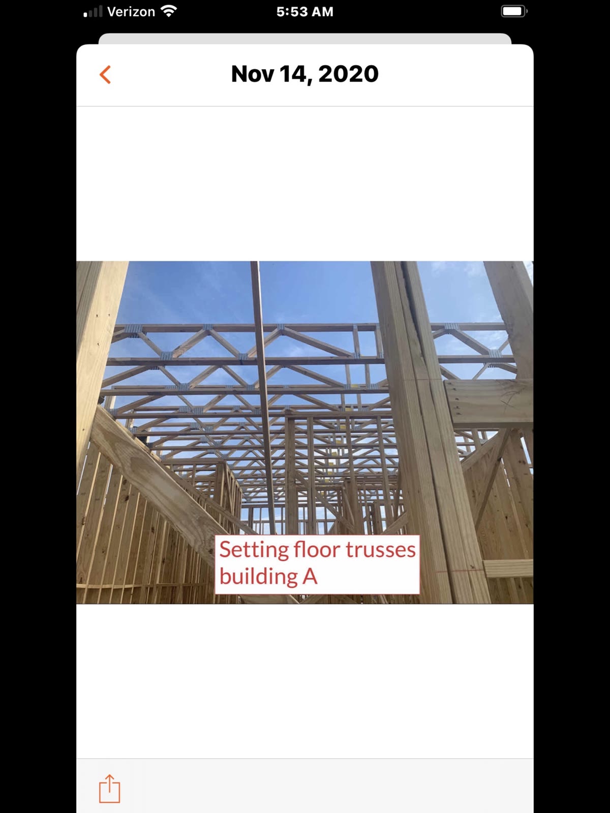 Close-up view looking up at floor trusses being set on Building A