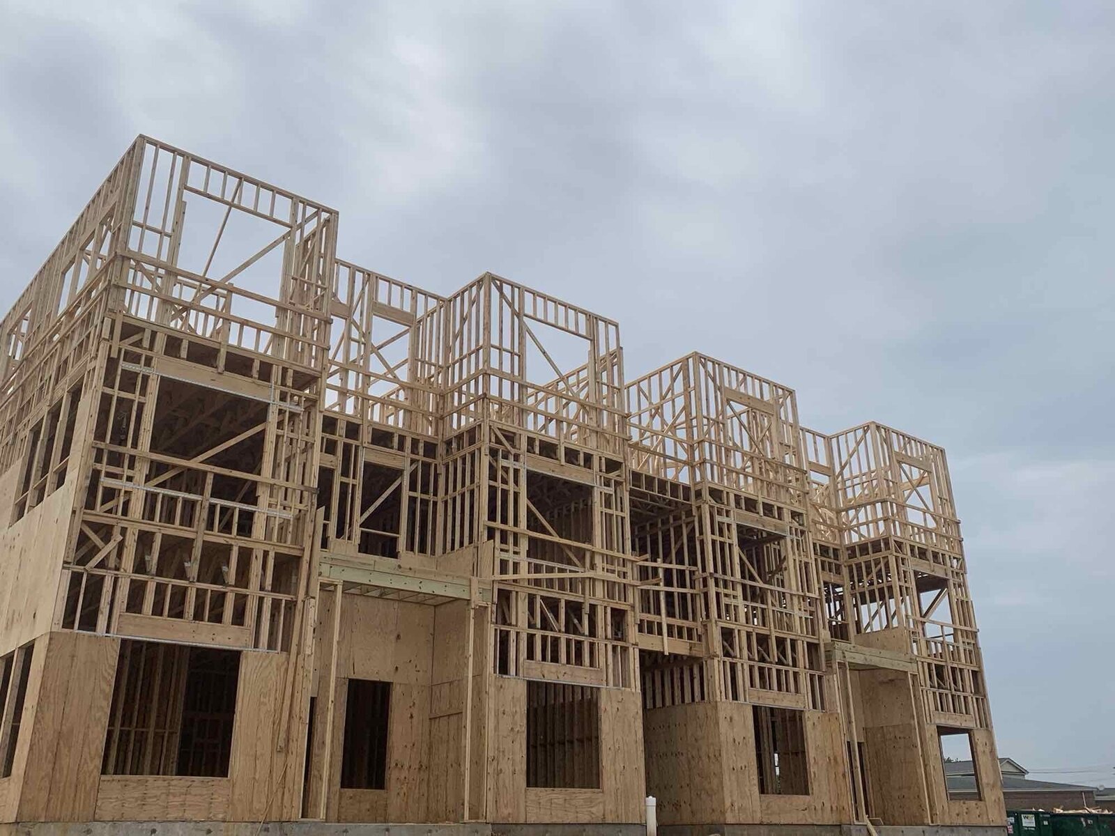 Aerial view of a multi-building complex with wood-frame construction in progress