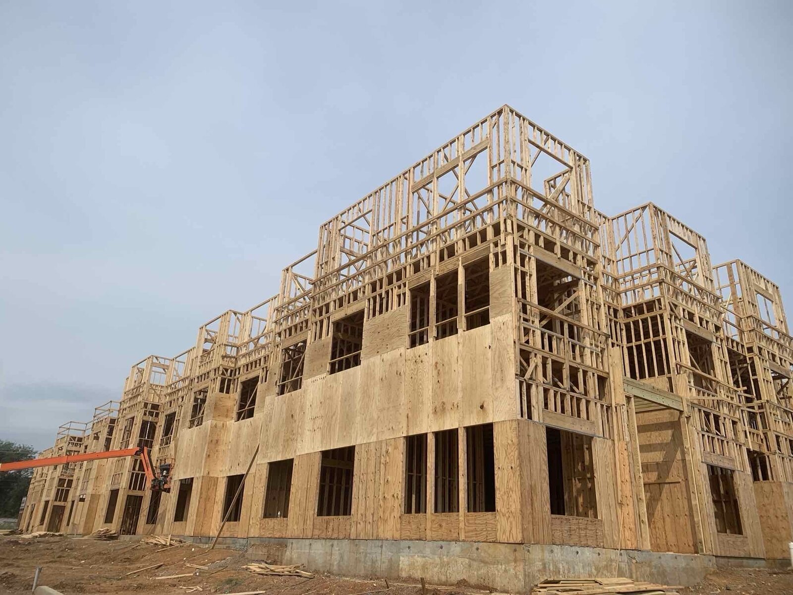 Aerial angle of framed multi-family buildings on an active job site