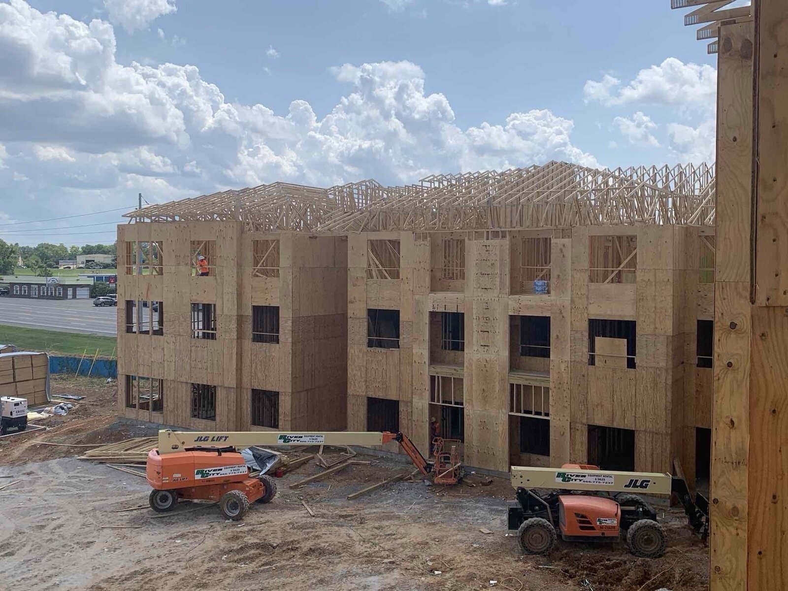 Multi-family building under construction with lift equipment on site