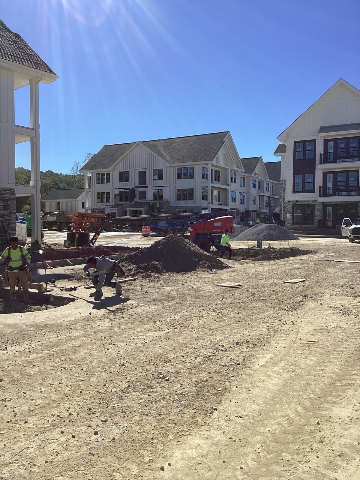 Row of newly framed multi-family buildings along paved road