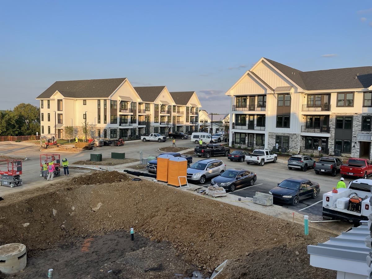 Completed clubhouse and amenity building with timber-frame porch and modern exterior